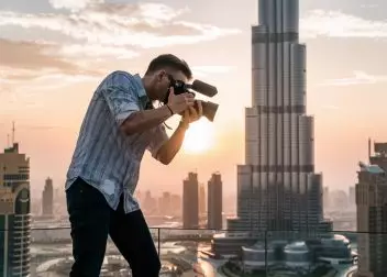 videographer taking video in front of burj khalifa