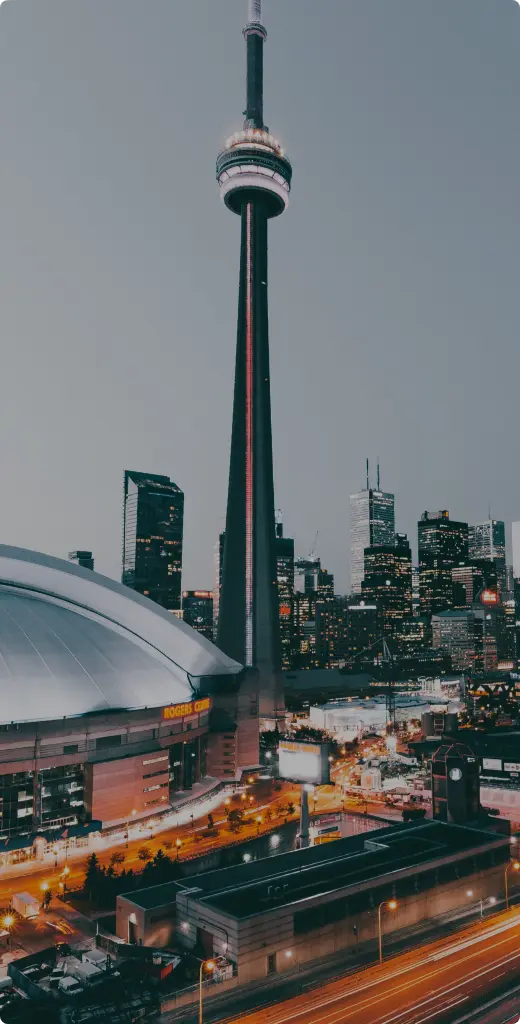 Toronto skyline featuring the CN Tower and Rogers Centre during evening light