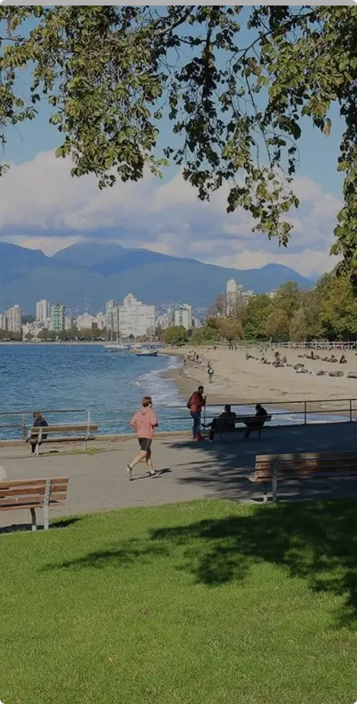 Scenic view of Vancouver waterfront with city skyline and mountains in the background