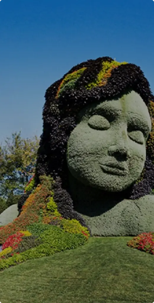 Moss-covered sculpture of a face at Montreal Botanical Garden