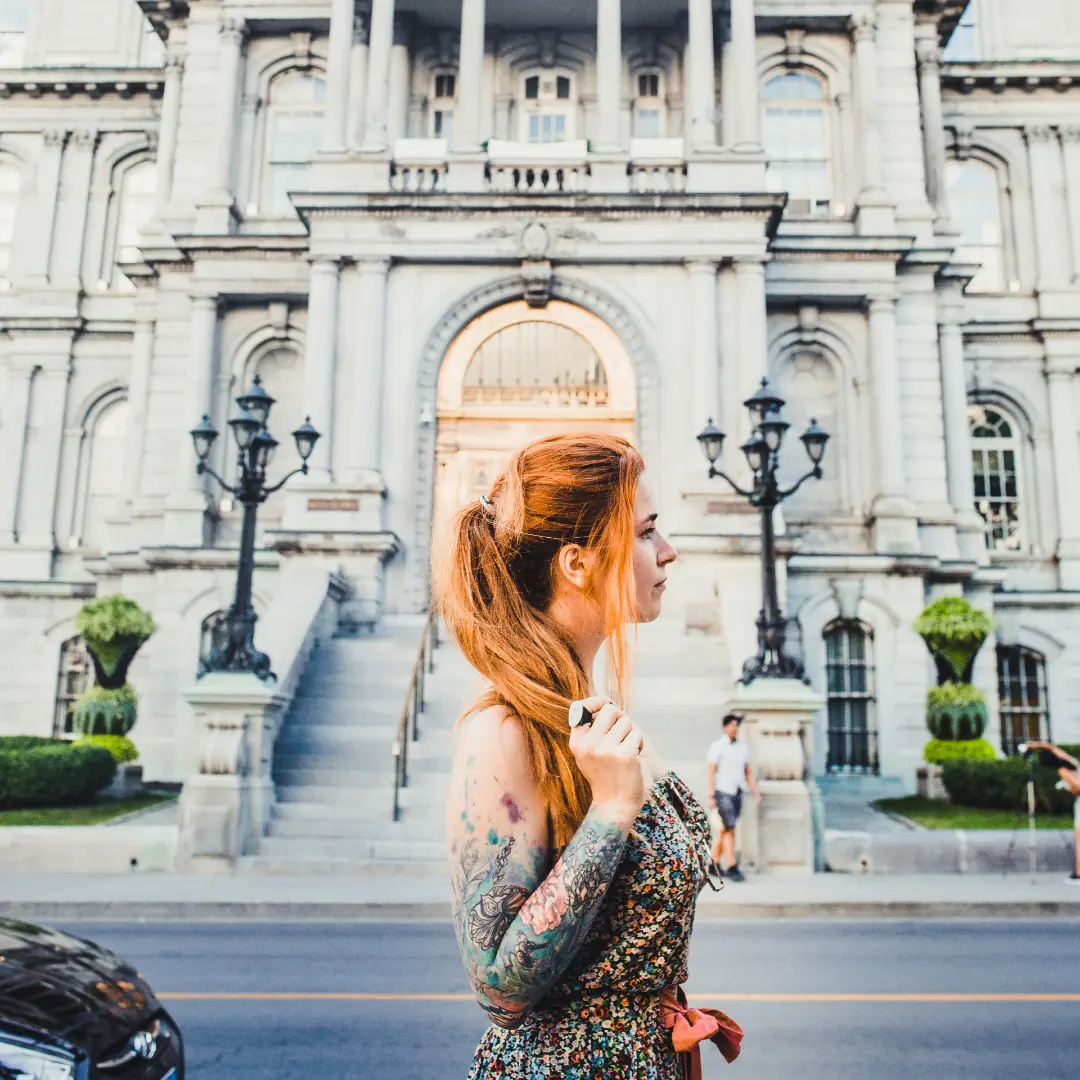 Woman posing in front of the Palace of Justice in Montreal, Quebec