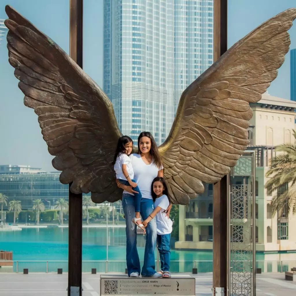 mother and kids pose in front of Burj Khalifa